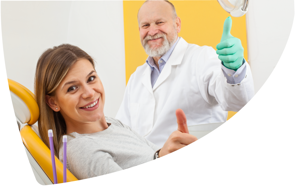 dentist with patient giving thumbs up