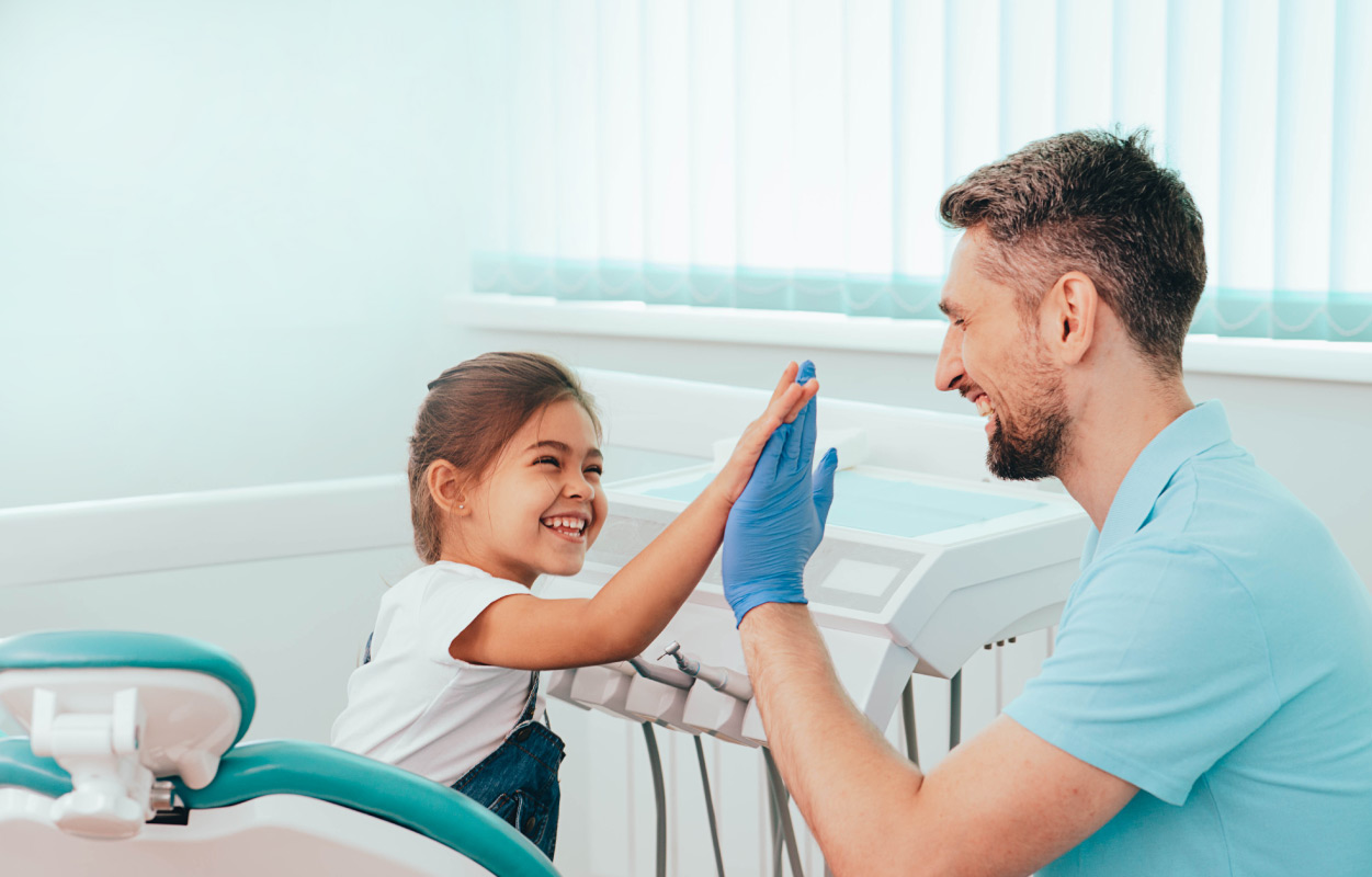 dentist high-fiving child