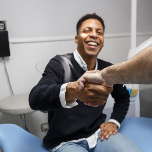 dentist patient shaking hands with dentist