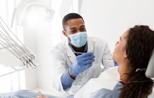 woman getting dental work done on dental chair