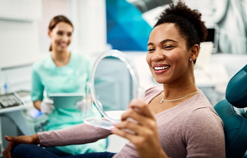 dental patient looking in mirror