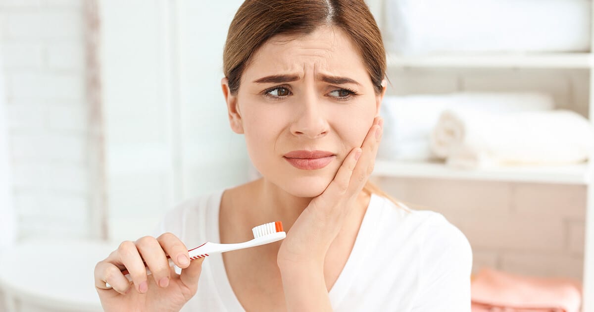 woman a holding toothbrush