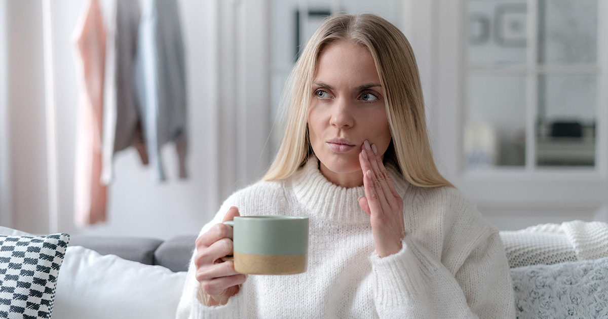 Woman experiencing pain from tooth sensitivity