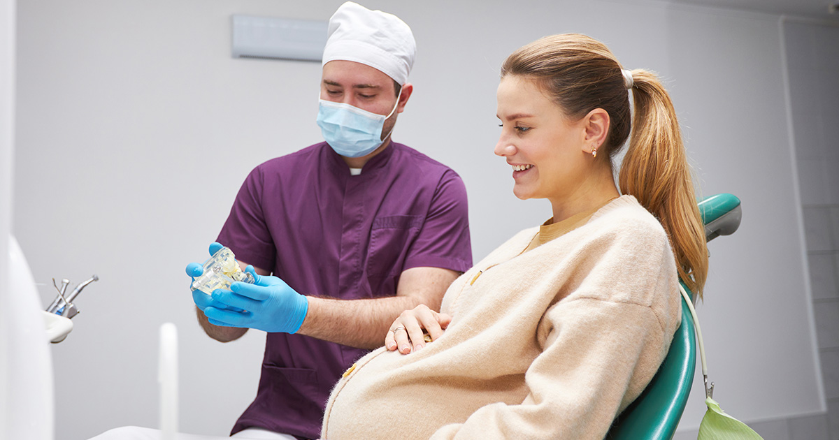 Pregnant woman at dental appointment.